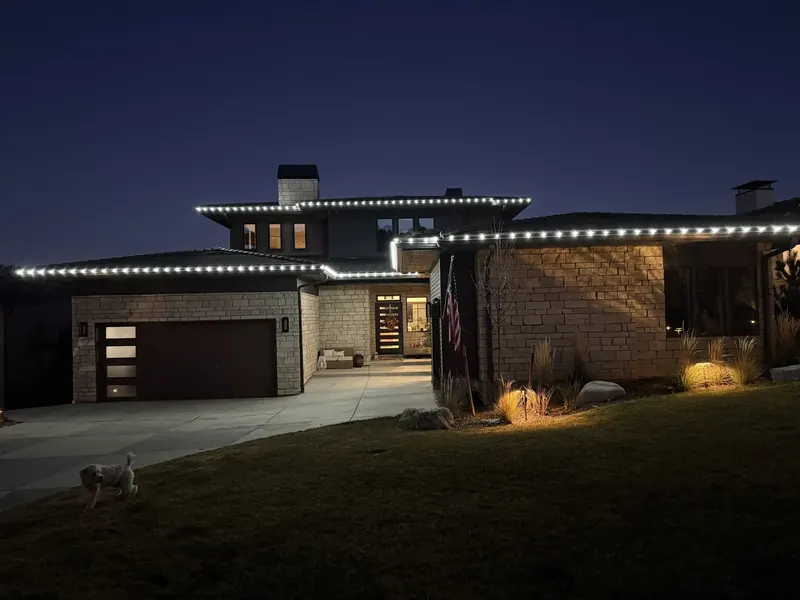 Modern prairie-style home with cool white roofline lights